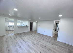 Unfurnished view of living room, bar area and kitchen. Photo taken after renovation before owners moved in.