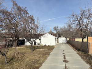 View of home's exterior with a large front lawn and one car garage