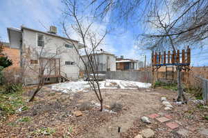 Backyard layered in snow featuring central air condition unit