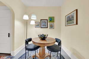 Dining area featuring a textured ceiling