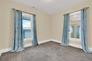 Empty bedroom featuring carpet floors