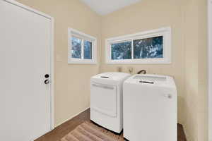 Laundry room on main floor with separate washer and dryer and tile patterned flooring