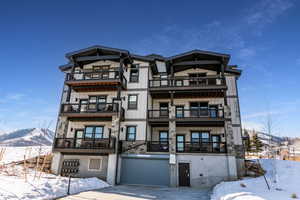 Snow covered building with a mountain view