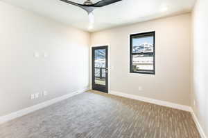 Carpeted empty room with ceiling fan