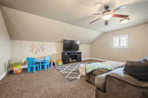 Game room featuring carpet flooring, ceiling fan, and vaulted ceiling