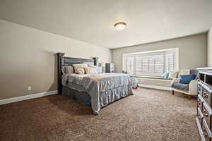 Carpeted bedroom with a textured ceiling