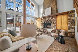 Living room with a towering ceiling and a fireplace