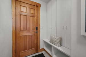 Mudroom featuring light tile patterned floors