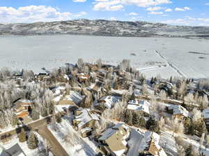 Snowy aerial view with a water and mountain view