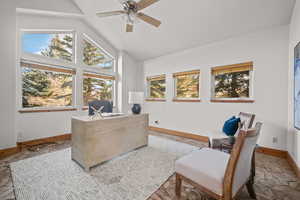 Office area with vaulted ceiling and ceiling fan