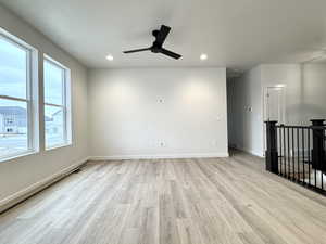 Unfurnished room featuring ceiling fan and light hardwood / wood-style floors