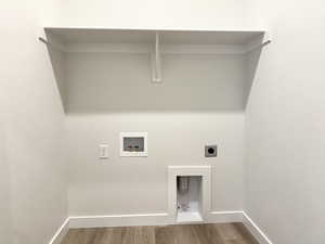 Clothes washing area featuring hookup for a washing machine, hardwood / wood-style floors, and hookup for an electric dryer