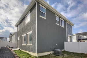 NE Corner of Home. View of side of home featuring central AC unit