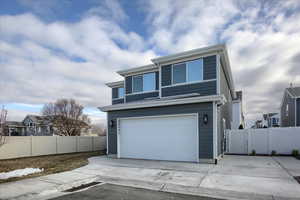 View of front of house with a garage and RV Pad