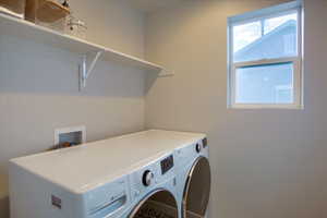 Convenient Second floor laundry room with shelf and window