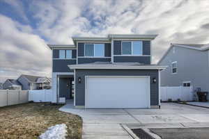 View of front of house featuring a garage and RV Pad