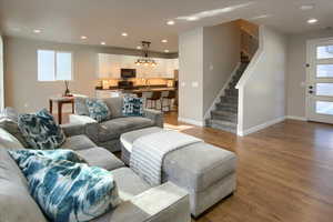 Living room featuring sink, a healthy amount of sunlight, and light hardwood / wood-style flooring