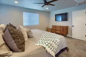 Primary bedroom featuring ceiling fan