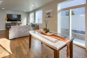 Open Great Room. Dining space featuring wood-type flooring. Sliding glass door out to back and side yards.