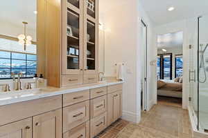 Primary Bathroom featuring vanity, an enclosed shower, and a wealth of natural light