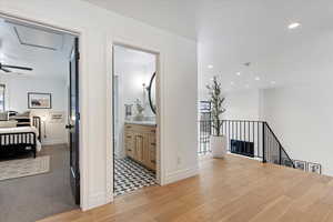 Hallway with light hardwood / wood-style flooring and a healthy amount of sunlight