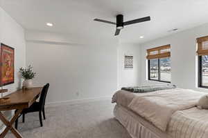 Basement apartment bedroom with carpeted bedroom with ceiling fan