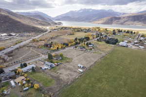 Drone / aerial view featuring a water and mountain view