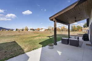 View of yard featuring outdoor lounge area, a mountain view, and a patio area