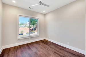 Unfurnished room featuring hardwood / wood-style flooring and ceiling fan