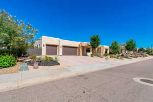 Pueblo revival-style home with a garage