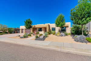 Pueblo revival-style home with a garage