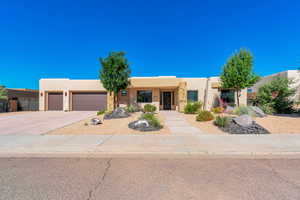 Southwest-style home featuring a garage