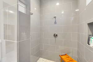 Bathroom featuring tiled shower