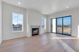 Unfurnished living room with light hardwood / wood-style floors