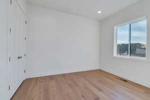 Unfurnished bedroom featuring light hardwood / wood-style floors