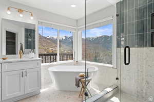 Bathroom featuring a mountain view, plus walk in shower, and vanity