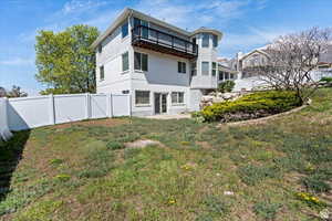 Rear view of property with a yard