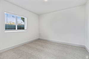 Spare room featuring light colored carpet