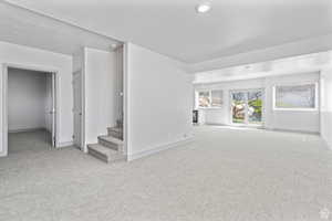 Unfurnished living room with light colored carpet