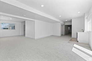 Unfurnished living room featuring light carpet