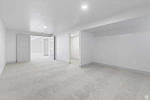 Interior space with a textured ceiling and light colored carpet