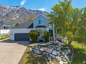 View of front of property featuring a mountain view and a garage