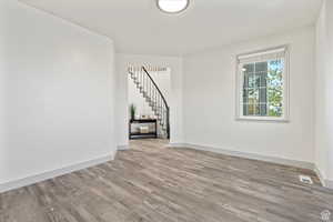 Unfurnished room with light wood-type flooring