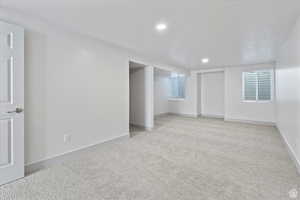 Carpeted empty room featuring a textured ceiling