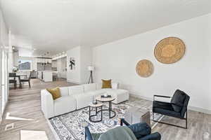 Living room with light hardwood / wood-style flooring