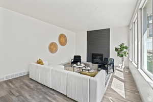 Living room featuring a fireplace and light hardwood / wood-style flooring