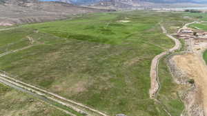 Aerial view of property and surrounding area featuring mountains and rural landscape