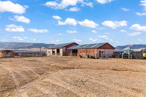 Exterior space featuring a mountain view and an outdoor structure