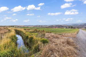 Property view of mountains featuring a rural view and a water view