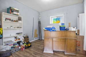 Home office featuring dark wood-type flooring